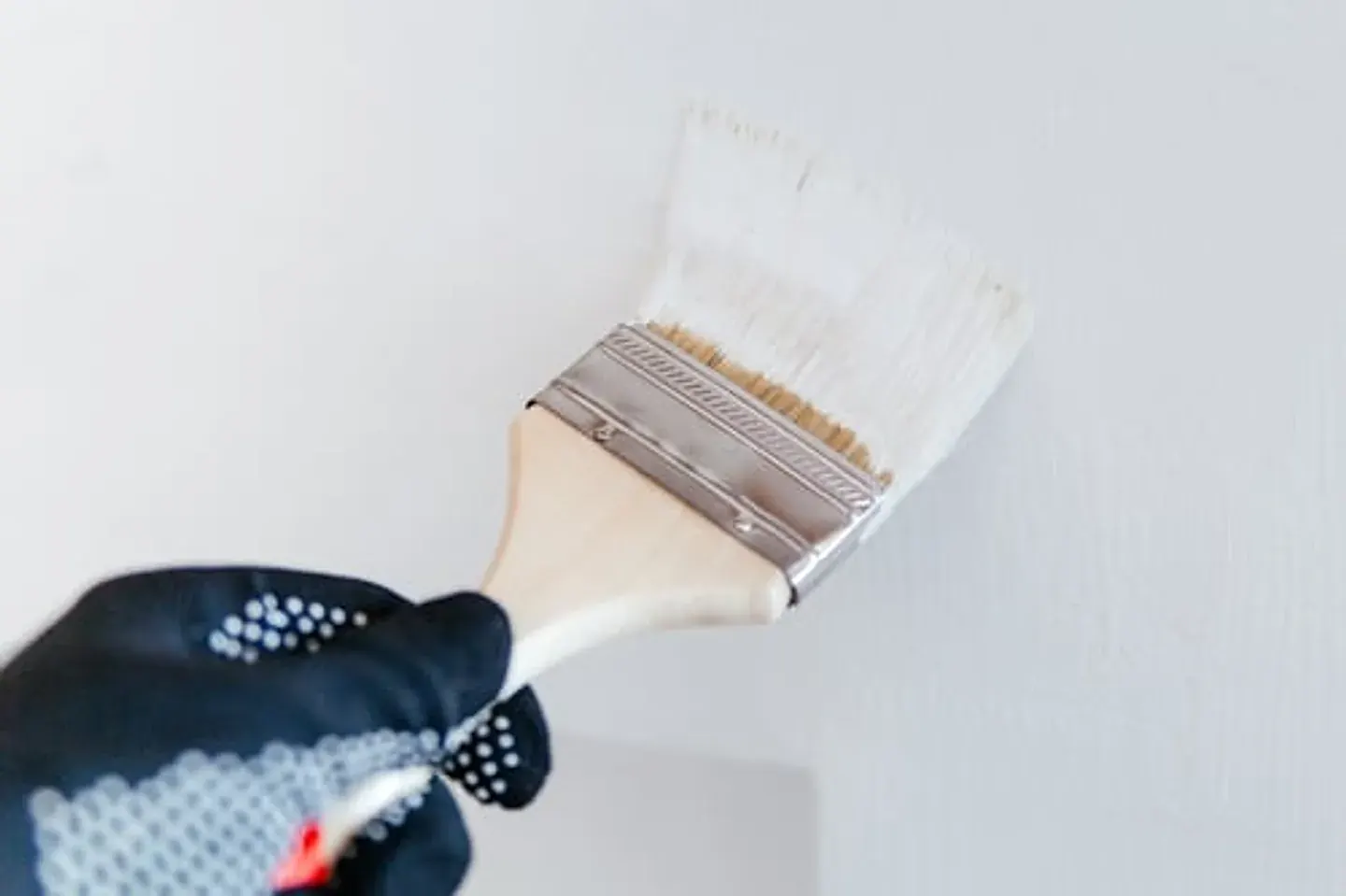 Painter applying a smooth finish coat to an interior wall