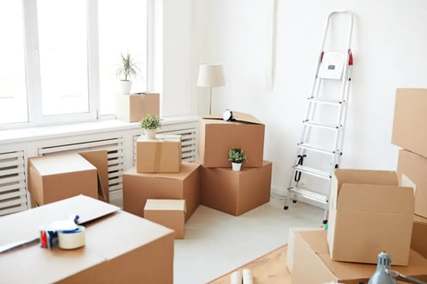 Moving boxes in an empty room prepared for move-out cleaning